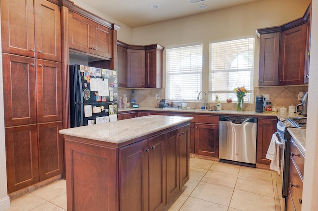 7951 N Fine Ave, Fresno, CA 93720 - kitchen featuring stainless steel appliances, light tile patterned floors, decorative backsplash, and a kitchen island