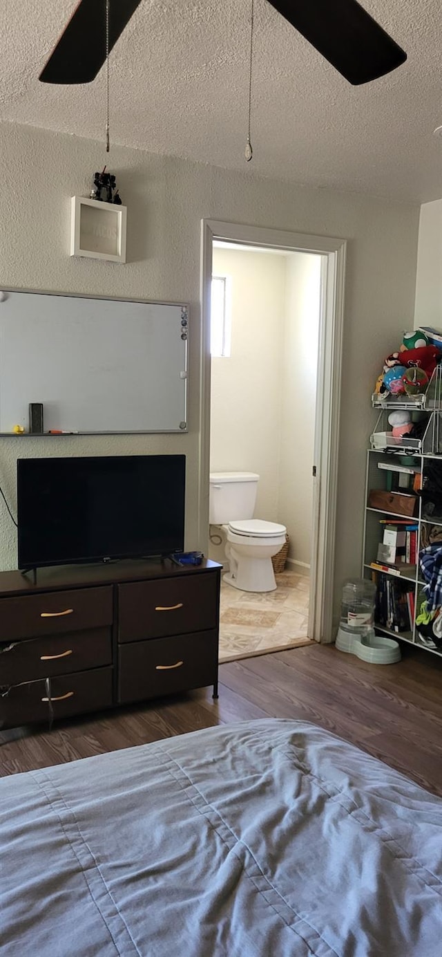 917 E Fountain Way, Fresno, CA 93704 - bedroom with dark wood-style flooring, a textured ceiling, ensuite bath, and a ceiling fan