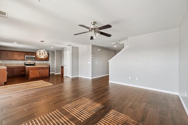 376 S Knox St, Madera, CA 93638 - unfurnished living room featuring dark wood-style floors, a ceiling fan, recessed lighting, and a chandelier