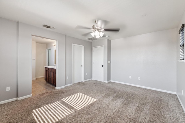 376 S Knox St, Madera, CA 93638 - unfurnished bedroom with light colored carpet, ensuite bath, and a ceiling fan
