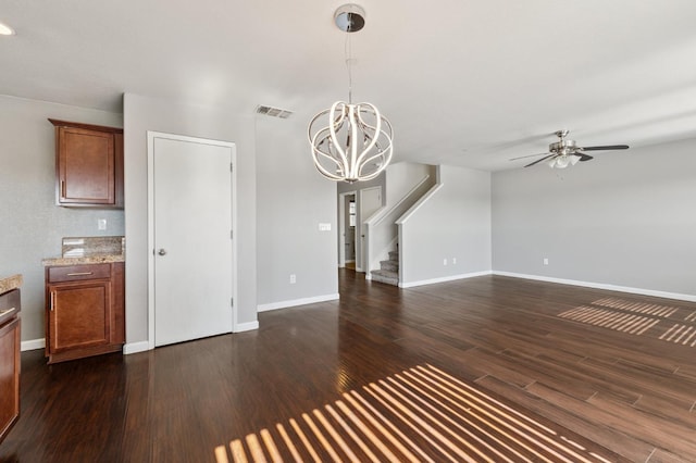 376 S Knox St, Madera, CA 93638 - unfurnished living room with ceiling fan, dark wood-type flooring, a chandelier, and stairs
