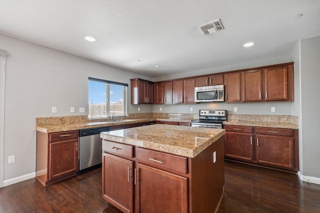 376 S Knox St, Madera, CA 93638 - kitchen featuring appliances with stainless steel finishes, a center island, dark wood-type flooring, tile counters, and recessed lighting
