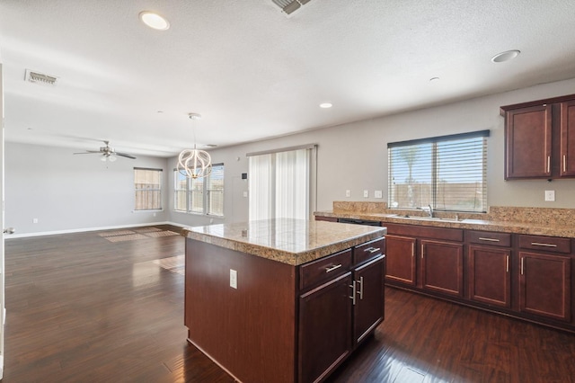 376 S Knox St, Madera, CA 93638 - kitchen featuring plenty of natural light, dark wood-style flooring, a kitchen island, recessed lighting, and light countertops