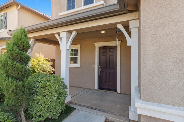 376 S Knox St, Madera, CA 93638 - doorway to property with stucco siding and covered porch