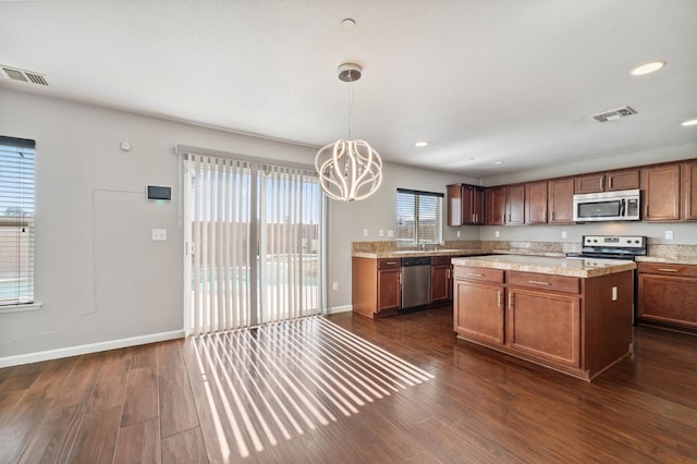 376 S Knox St, Madera, CA 93638 - kitchen with stainless steel appliances, a chandelier, dark wood-style floors, a kitchen island, and pendant lighting