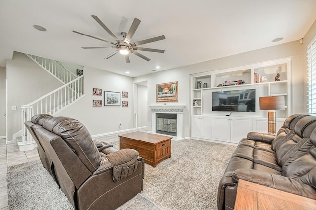 4626 N Arrow Ridge Way, Clovis, CA 93619 - living room with stairway, ceiling fan, a glass covered fireplace, built in features, and recessed lighting