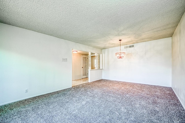 1445 W Ellery Way, Fresno, CA 93711 - unfurnished room featuring a chandelier, carpet floors, and a textured ceiling