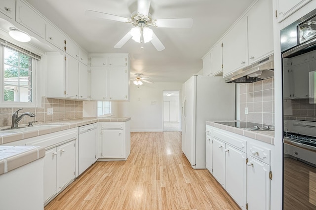 1445 W Ellery Way, Fresno, CA 93711 - kitchen with white dishwasher, stainless steel oven, ceiling fan, tile counters, and black electric stovetop