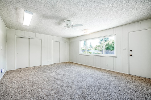 1445 W Ellery Way, Fresno, CA 93711 - unfurnished bedroom with two closets, carpet, ceiling fan, and a textured ceiling