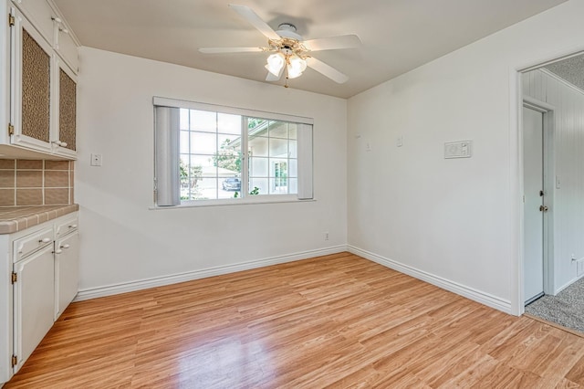 1445 W Ellery Way, Fresno, CA 93711 - unfurnished dining area with light wood-type flooring and a ceiling fan