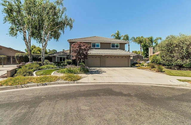 3012 Fairmont Ct, Madera, CA 93637 - view of front of home with a tile roof, stucco siding, driveway, and an attached garage