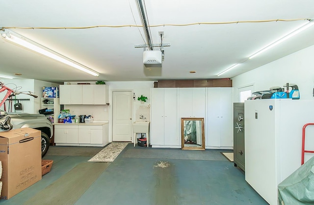 3012 Fairmont Ct, Madera, CA 93637 - garage featuring freestanding refrigerator and a garage door opener