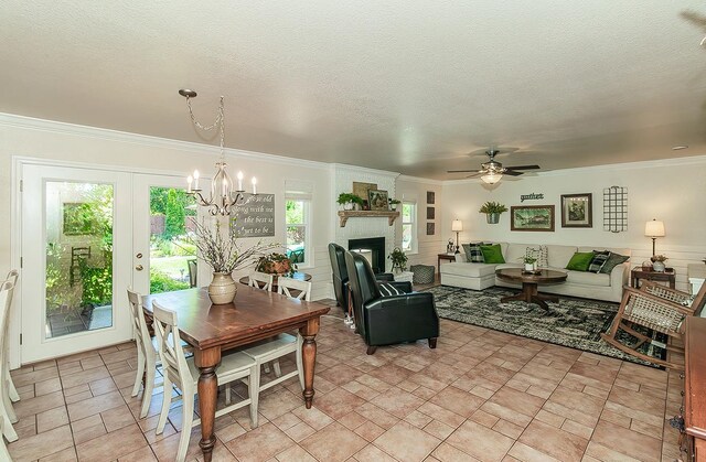 3012 Fairmont Ct, Madera, CA 93637 - dining space featuring a chandelier, a ceiling fan, ornamental molding, a brick fireplace, and a textured ceiling