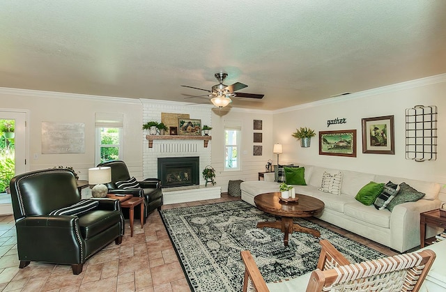 3012 Fairmont Ct, Madera, CA 93637 - living room featuring plenty of natural light, ornamental molding, ceiling fan, a fireplace, and a textured ceiling