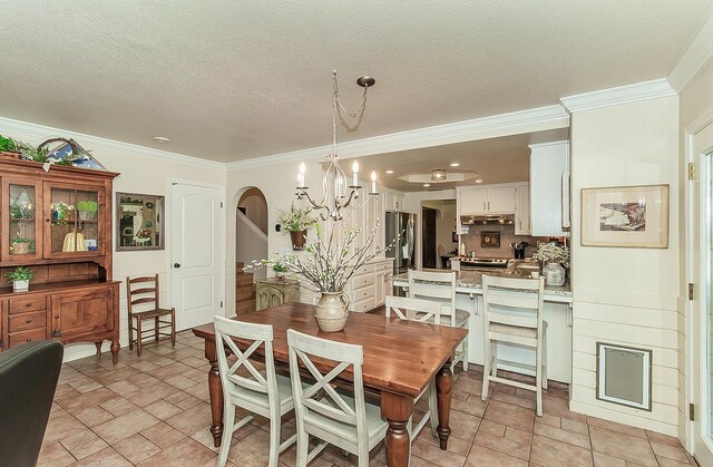 3012 Fairmont Ct, Madera, CA 93637 - dining area featuring a chandelier, crown molding, a textured ceiling, light stone finish floors, and arched walkways