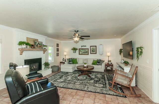 3012 Fairmont Ct, Madera, CA 93637 - living area featuring ceiling fan, ornamental molding, a textured ceiling, and a fireplace