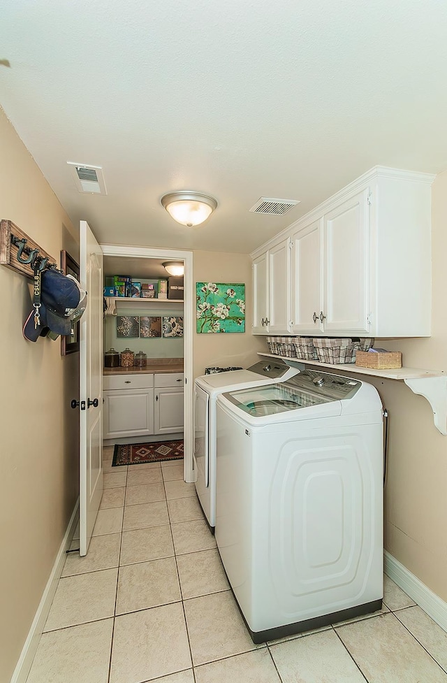 3012 Fairmont Ct, Madera, CA 93637 - washroom featuring independent washer and dryer, cabinet space, and light tile patterned flooring