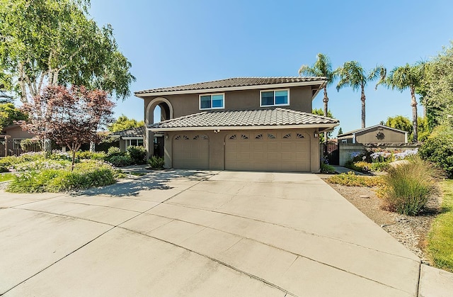 3012 Fairmont Ct, Madera, CA 93637 - mediterranean / spanish home with stucco siding, driveway, a tile roof, and an attached garage