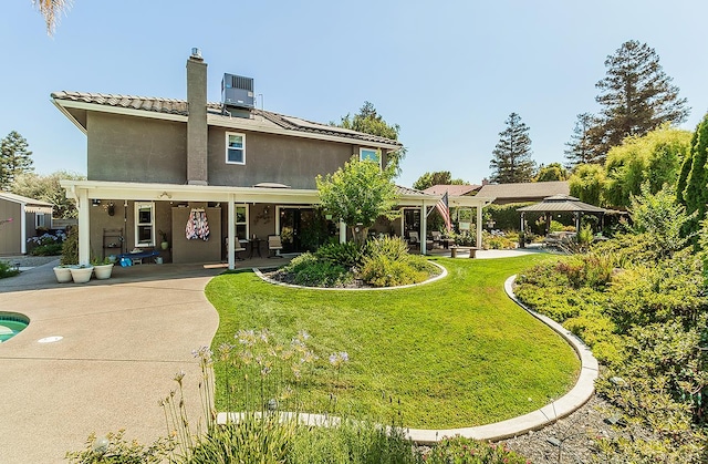 3012 Fairmont Ct, Madera, CA 93637 - rear view of house featuring a gazebo, a yard, stucco siding, a chimney, and a patio
