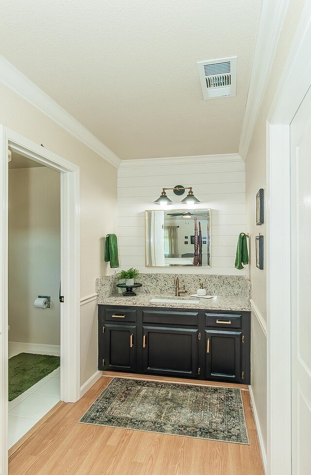 3012 Fairmont Ct, Madera, CA 93637 - bathroom with ornamental molding, vanity, and wood finished floors