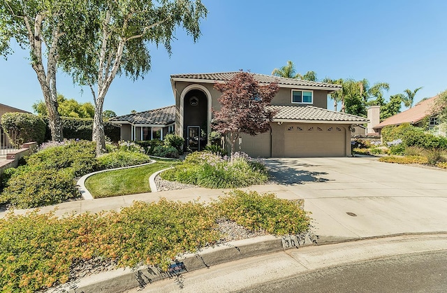3012 Fairmont Ct, Madera, CA 93637 - mediterranean / spanish-style home featuring a tiled roof, stucco siding, driveway, and an attached garage