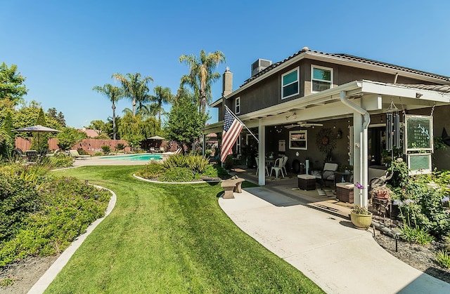 3012 Fairmont Ct, Madera, CA 93637 - back of house featuring a patio, a fenced backyard, a ceiling fan, and a chimney
