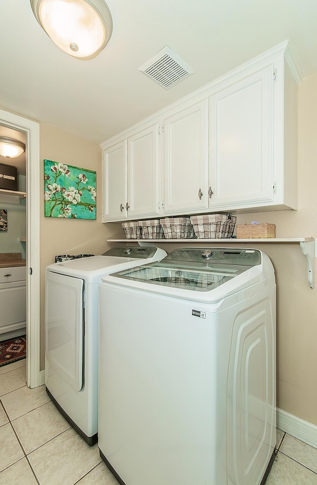 3012 Fairmont Ct, Madera, CA 93637 - washroom featuring cabinet space, washer and clothes dryer, and light tile patterned floors