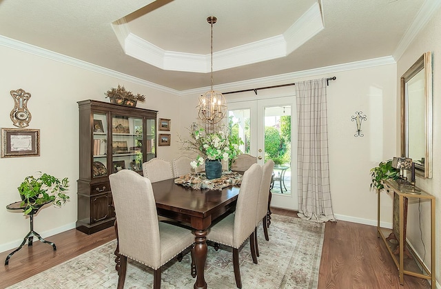 3012 Fairmont Ct, Madera, CA 93637 - dining room featuring wood finished floors, a tray ceiling, a chandelier, and crown molding