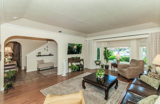 3012 Fairmont Ct, Madera, CA 93637 - living room featuring arched walkways, a textured ceiling, wood finished floors, and ornamental molding