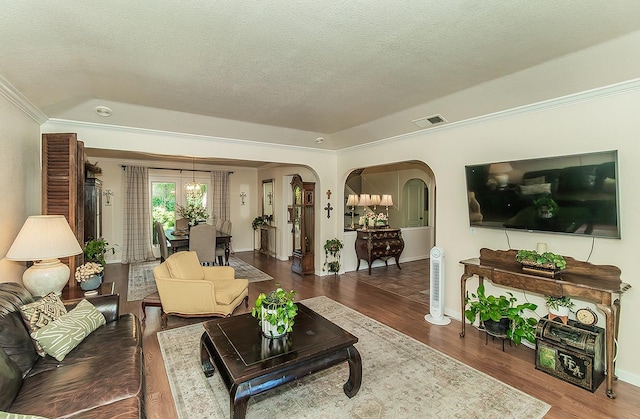 3012 Fairmont Ct, Madera, CA 93637 - living room with arched walkways, ornamental molding, a textured ceiling, and wood finished floors