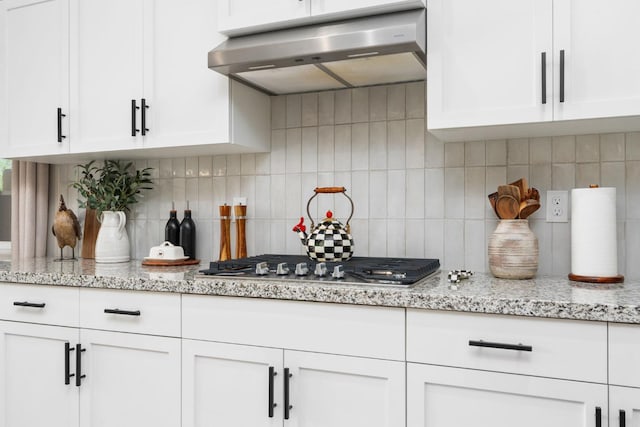 1275 Traverse Dr S, Madera, CA 93636 - kitchen featuring range hood, stainless steel gas cooktop, tasteful backsplash, white cabinetry, and light stone counters