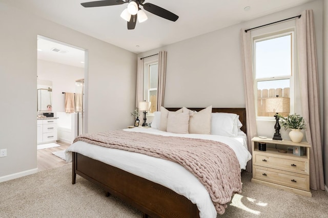 1275 Traverse Dr S, Madera, CA 93636 - bedroom with light colored carpet, connected bathroom, and ceiling fan