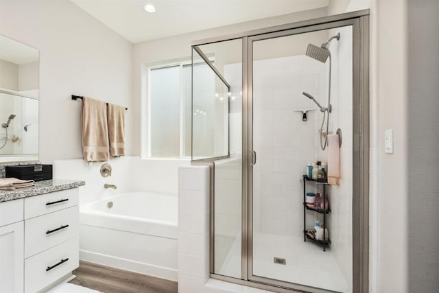 1275 Traverse Dr S, Madera, CA 93636 - full bath featuring vanity, a shower stall, a garden tub, wood finished floors, and recessed lighting