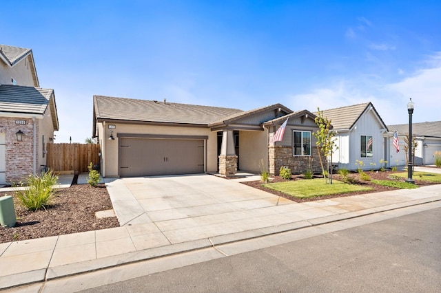 1275 Traverse Dr S, Madera, CA 93636 - view of front facade featuring an attached garage, concrete driveway, a tile roof, and stone siding