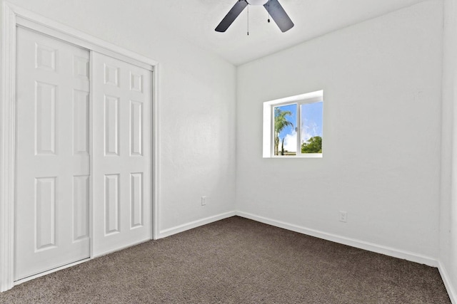 124 E 4th St, Hanford, CA 93230 - unfurnished bedroom featuring dark carpet, a closet, and ceiling fan