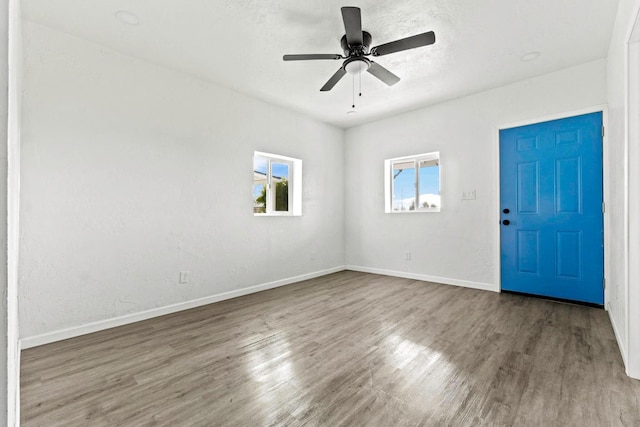 124 E 4th St, Hanford, CA 93230 - empty room with wood finished floors and ceiling fan