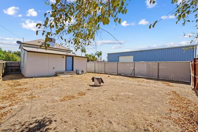 124 E 4th St, Hanford, CA 93230 - view of yard featuring a detached garage and an outdoor structure