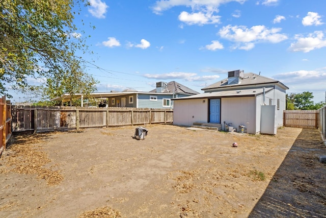 124 E 4th St, Hanford, CA 93230 - rear view of house with a fenced backyard