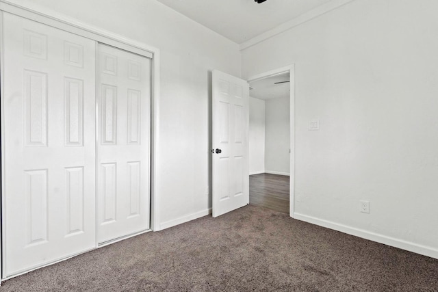 124 E 4th St, Hanford, CA 93230 - unfurnished bedroom with dark colored carpet and a closet