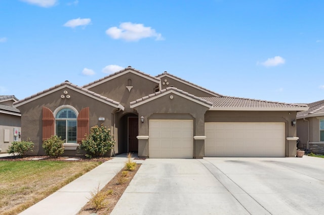 1724 W Sedona Ave, Visalia, CA 93291 - view of front of property featuring stucco siding, an attached garage, concrete driveway, a tiled roof, and a front yard