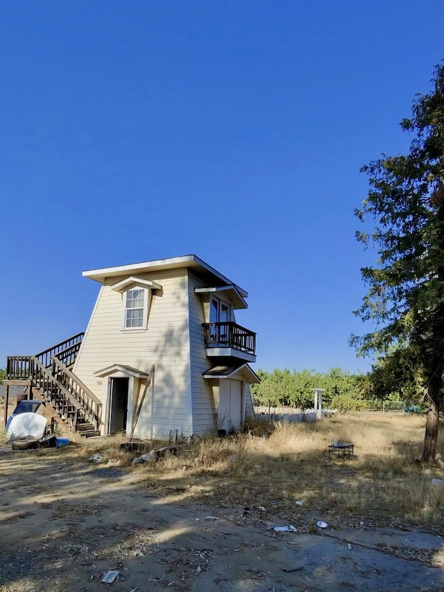 10220 E Tulare Ave, Sanger, CA 93657 - view of side of home featuring a balcony and stairway