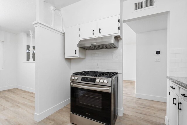 145 W Atchison Ave, Fresno, CA 93706 - kitchen with gas stove, under cabinet range hood, backsplash, and light wood-style flooring
