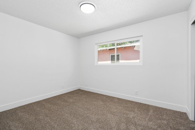 145 W Atchison Ave, Fresno, CA 93706 - unfurnished room with dark colored carpet and a textured ceiling
