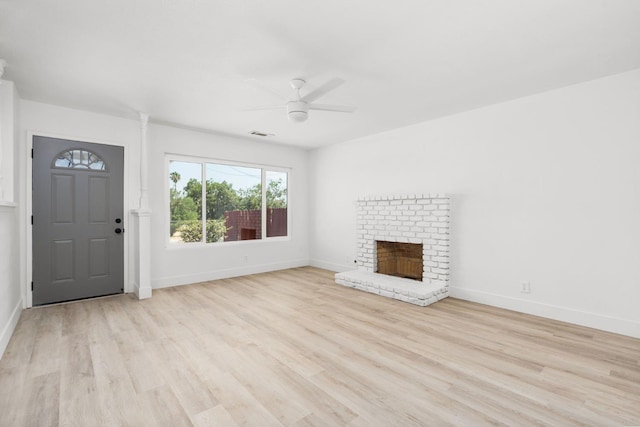 145 W Atchison Ave, Fresno, CA 93706 - unfurnished living room featuring a ceiling fan, light wood-style floors, and a brick fireplace