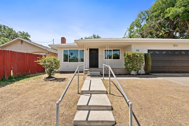 145 W Atchison Ave, Fresno, CA 93706 - ranch-style home featuring a chimney, stucco siding, and an attached garage