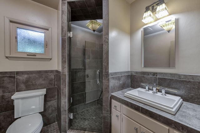 5679 N Van Ness Blvd, Fresno, CA 93711 - bathroom featuring tile walls, vanity, a stall shower, and wainscoting