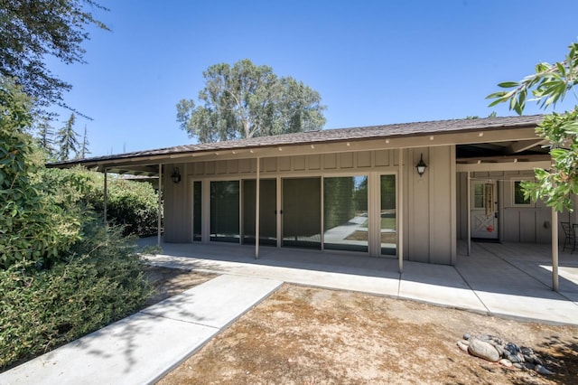 5679 N Van Ness Blvd, Fresno, CA 93711 - back of property featuring board and batten siding and a patio