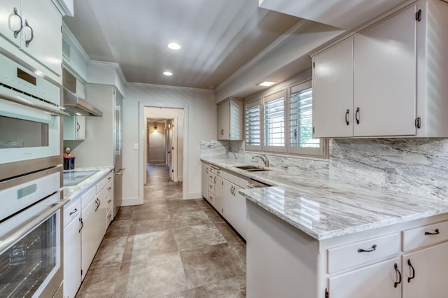5679 N Van Ness Blvd, Fresno, CA 93711 - kitchen featuring crown molding, double oven, backsplash, recessed lighting, and light stone counters