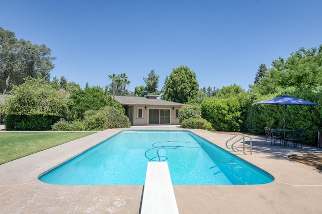 5679 N Van Ness Blvd, Fresno, CA 93711 - swimming pool featuring a patio area, a diving board, view of scattered trees, and a lawn