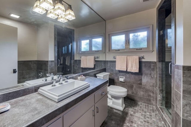 5679 N Van Ness Blvd, Fresno, CA 93711 - bathroom featuring tile walls, vanity, a shower stall, a chandelier, and wainscoting